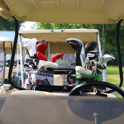 photo of golf clubs in golf cart at sebasticook valley fcu golf tournament
