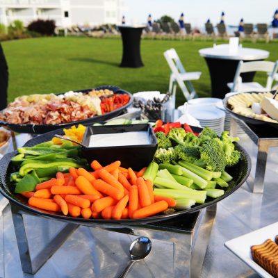 photo of veggie tray and other hors d’oeuvres on table outside