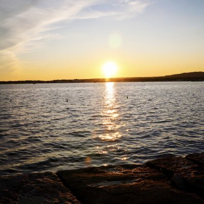 photo of sunset over ocean at rockland breakwater lighthouse