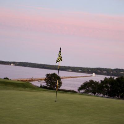 photo of flag in golf hole on the green